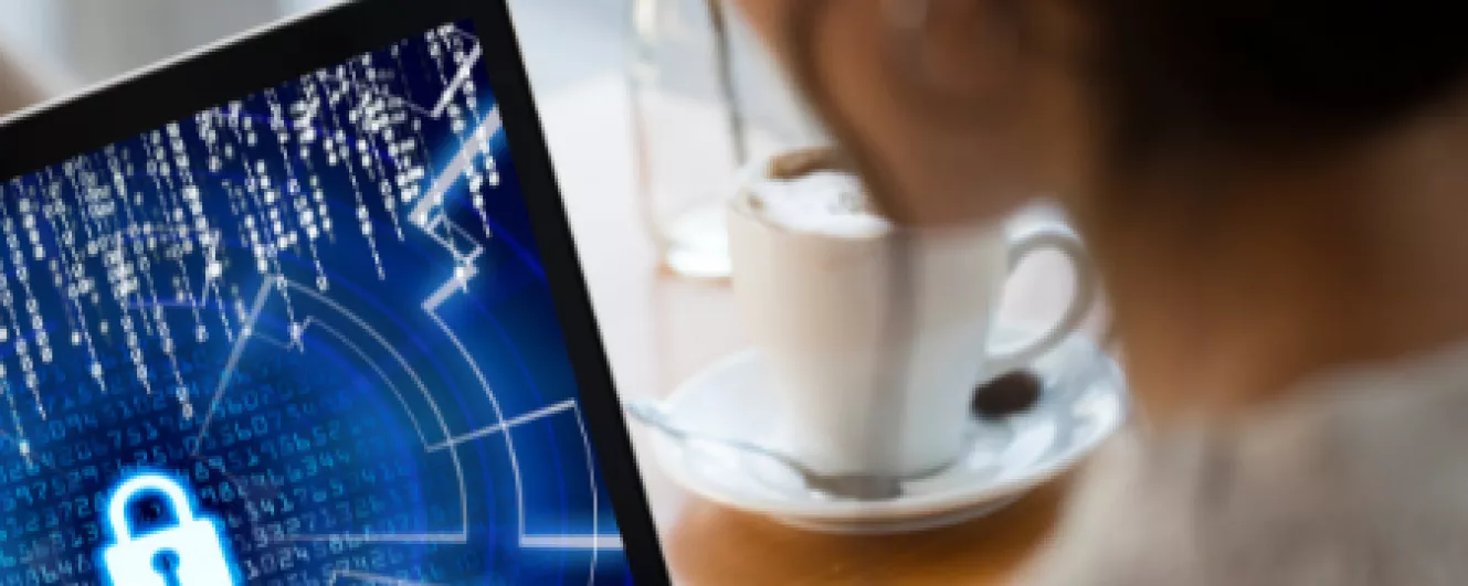 Cybersecurity - woman looking at screen with a virtual lock